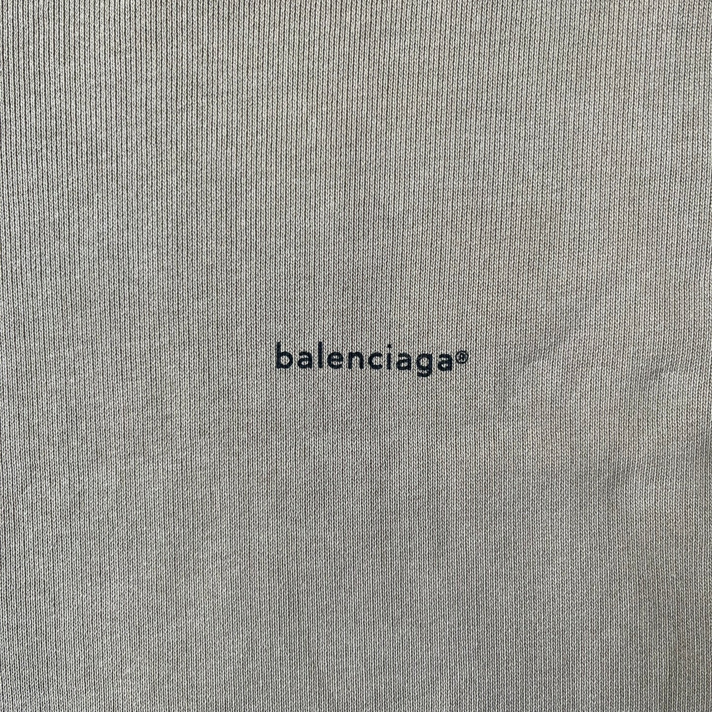 Balenciaga 2019 Khaki Small Logo Crewneck features a khaki 100% cotton construction with thick ribbed hems. A small black Balenciaga copyright logo is printed on the left chest. Made in Portugal.