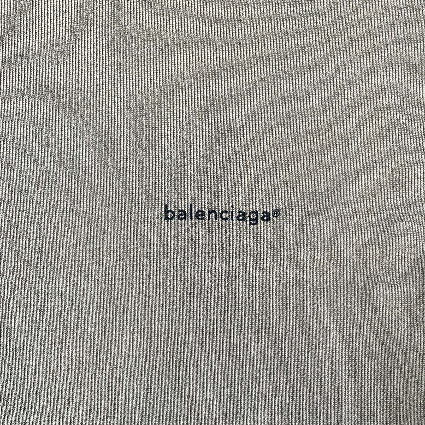 Balenciaga 2019 Khaki Small Logo Crewneck features a khaki 100% cotton construction with thick ribbed hems. A small black Balenciaga copyright logo is printed on the left chest. Made in Portugal.