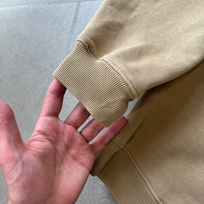 Balenciaga 2019 Khaki Small Logo Crewneck features a khaki 100% cotton construction with thick ribbed hems. A small black Balenciaga copyright logo is printed on the left chest. Made in Portugal.