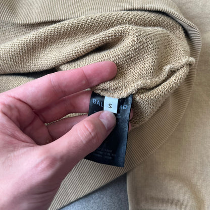 Balenciaga 2019 Khaki Small Logo Crewneck features a khaki 100% cotton construction with thick ribbed hems. A small black Balenciaga copyright logo is printed on the left chest. Made in Portugal.