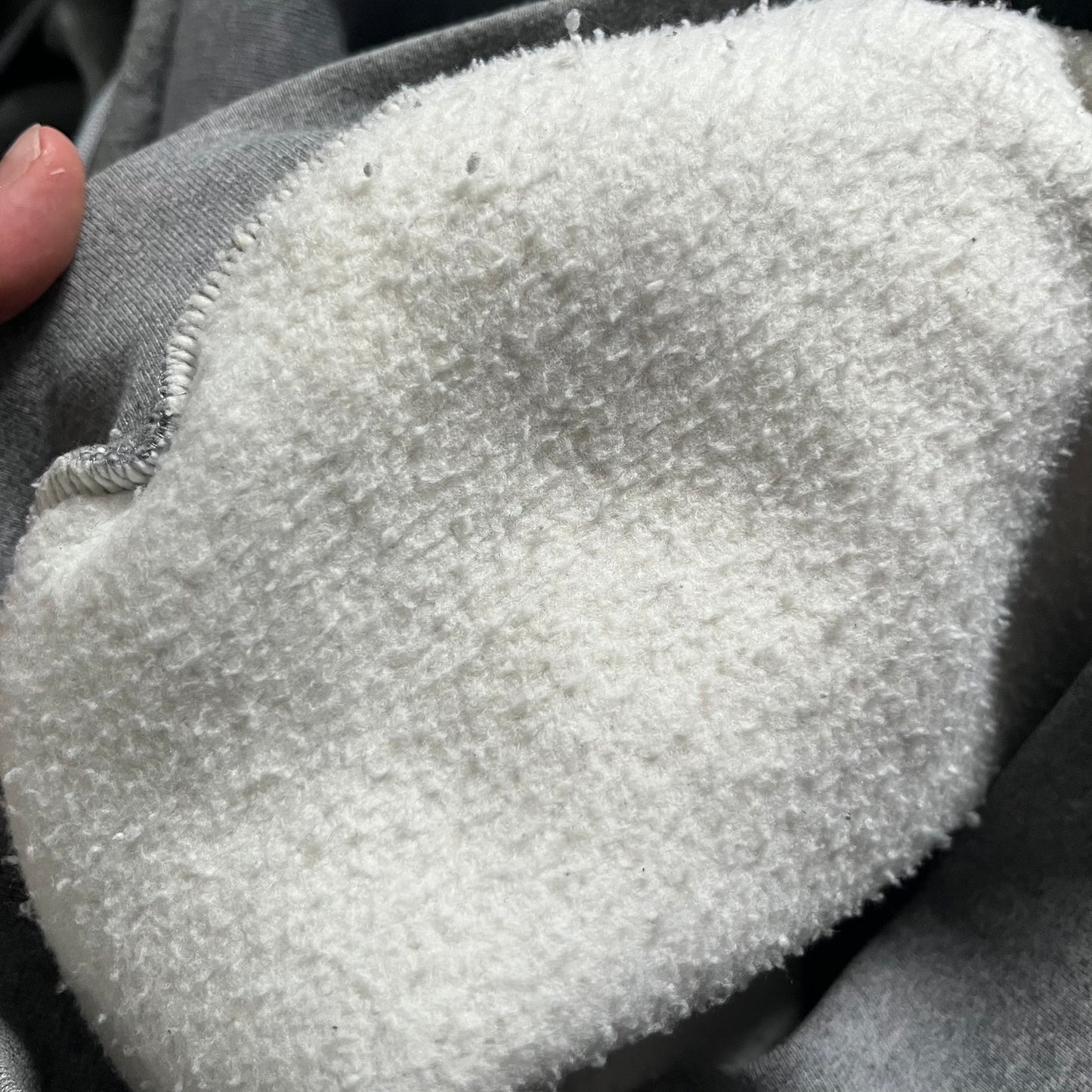 Balenciaga BB Crest Logo Hoodie in Heather Grey, crafted in Portugal from a heavyweight cotton-blend fleece (76% cotton, 24% polyester). The heather grey base features a dark navy BB emblem framed by laurel leaves and the Balenciaga logo text. Finished with dropped shoulders, ribbed edges, and a spacious front pocket, this oversized hoodie exemplifies elevated comfort and craftsmanship.