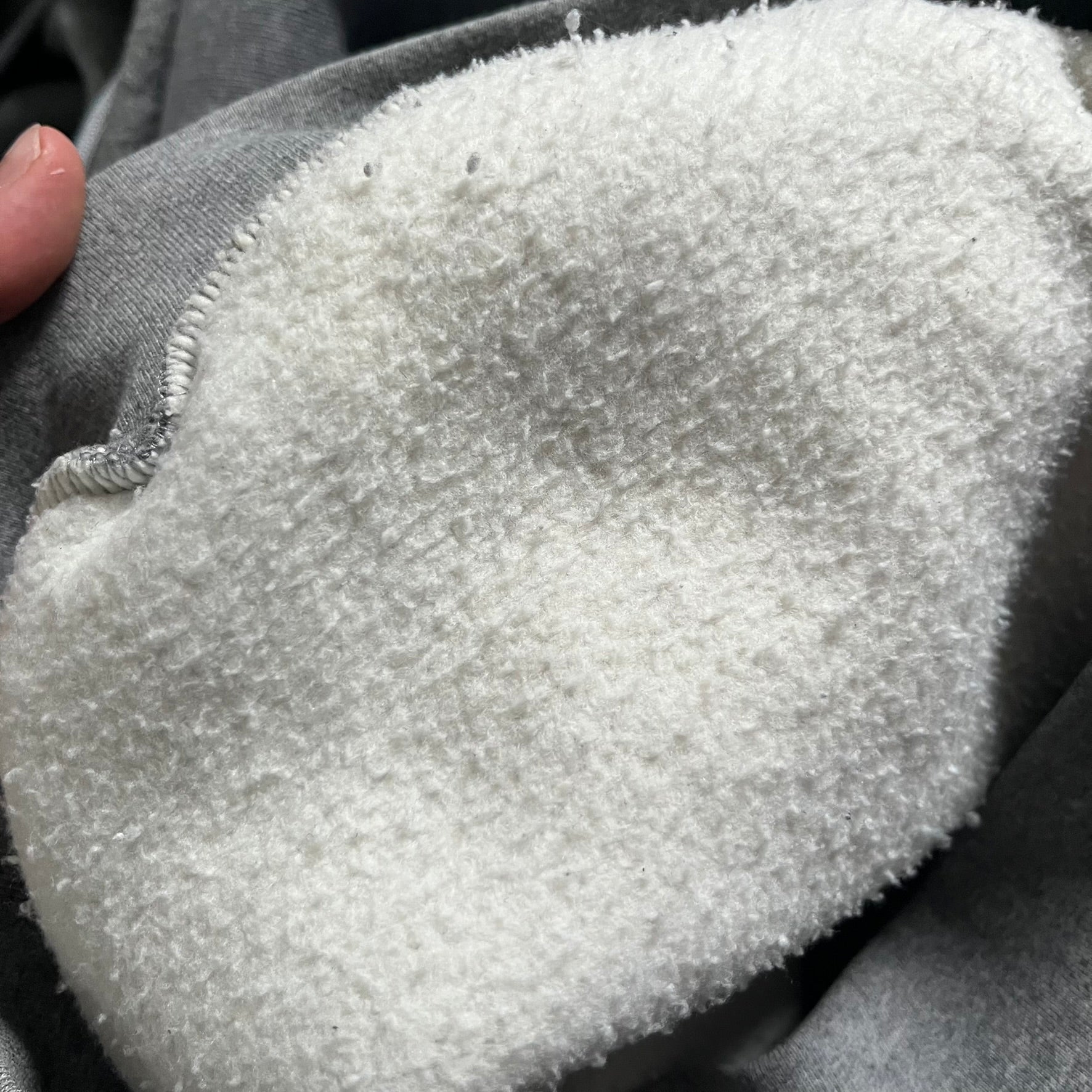 Balenciaga BB Crest Logo Hoodie in Heather Grey, crafted in Portugal from a heavyweight cotton-blend fleece (76% cotton, 24% polyester). The heather grey base features a dark navy BB emblem framed by laurel leaves and the Balenciaga logo text. Finished with dropped shoulders, ribbed edges, and a spacious front pocket, this oversized hoodie exemplifies elevated comfort and craftsmanship.