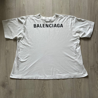 Balenciaga back logo tee from 2018, crafted in Portugal from soft white cotton. Designed with an oversized fit, it features a bold Balenciaga text logo across the upper back. Lower back part is a lot wider than front.