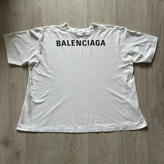 Balenciaga back logo tee from 2018, crafted in Portugal from soft white cotton. Designed with an oversized fit, it features a bold Balenciaga text logo across the upper back. Lower back part is a lot wider than front.