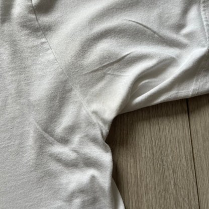 Balenciaga back logo tee from 2018, crafted in Portugal from soft white cotton. Designed with an oversized fit, it features a bold Balenciaga text logo across the upper back. Lower back part is a lot wider than front.