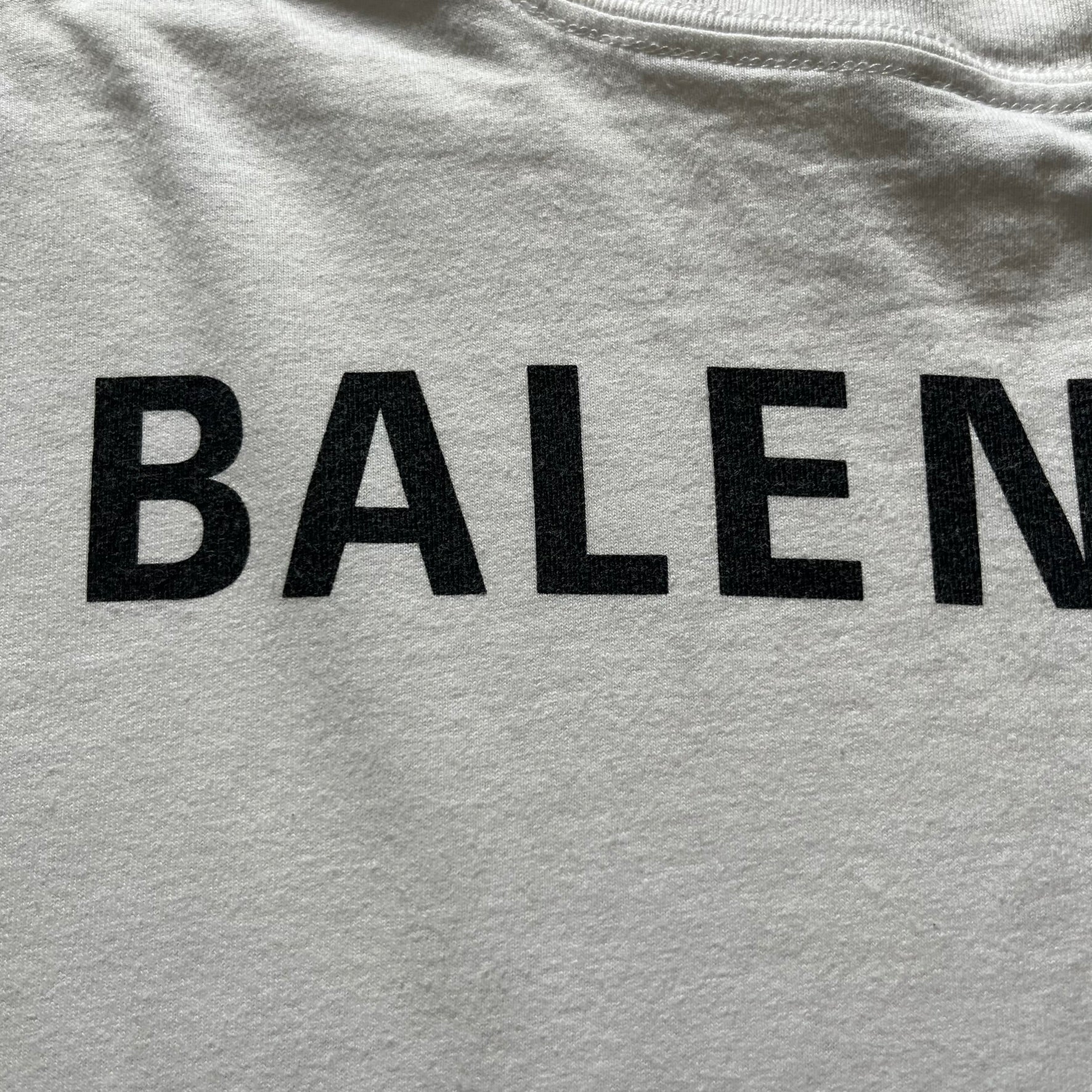 Balenciaga back logo tee from 2018, crafted in Portugal from soft white cotton. Designed with an oversized fit, it features a bold Balenciaga text logo across the upper back. Lower back part is a lot wider than front.