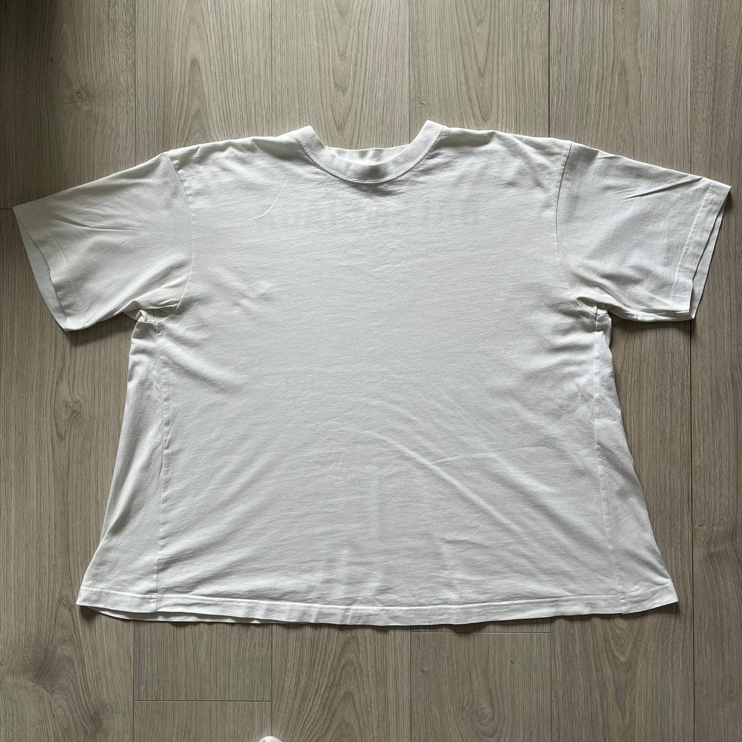 Balenciaga back logo tee from 2018, crafted in Portugal from soft white cotton. Designed with an oversized fit, it features a bold Balenciaga text logo across the upper back. Lower back part is a lot wider than front.