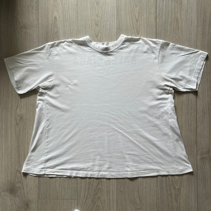 Balenciaga back logo tee from 2018, crafted in Portugal from soft white cotton. Designed with an oversized fit, it features a bold Balenciaga text logo across the upper back. Lower back part is a lot wider than front.