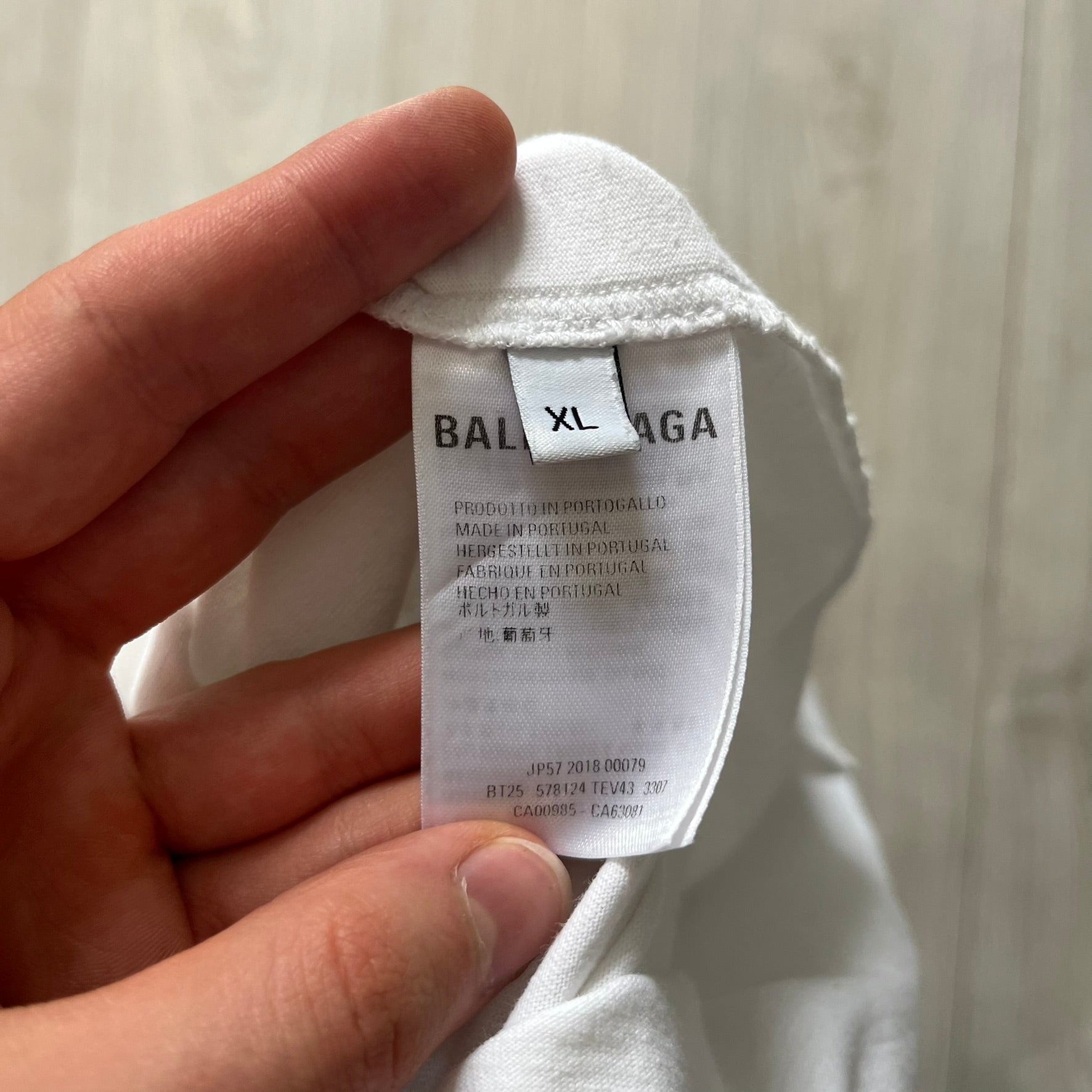 Balenciaga back logo tee from 2018, crafted in Portugal from soft white cotton. Designed with an oversized fit, it features a bold Balenciaga text logo across the upper back. Lower back part is a lot wider than front.