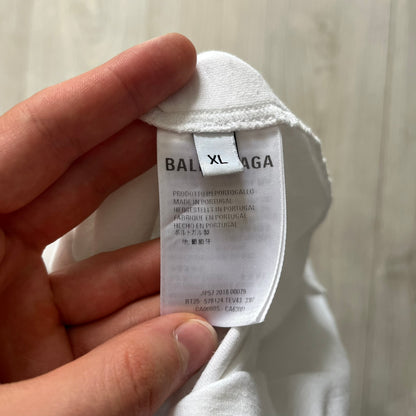 Balenciaga back logo tee from 2018, crafted in Portugal from soft white cotton. Designed with an oversized fit, it features a bold Balenciaga text logo across the upper back. Lower back part is a lot wider than front.