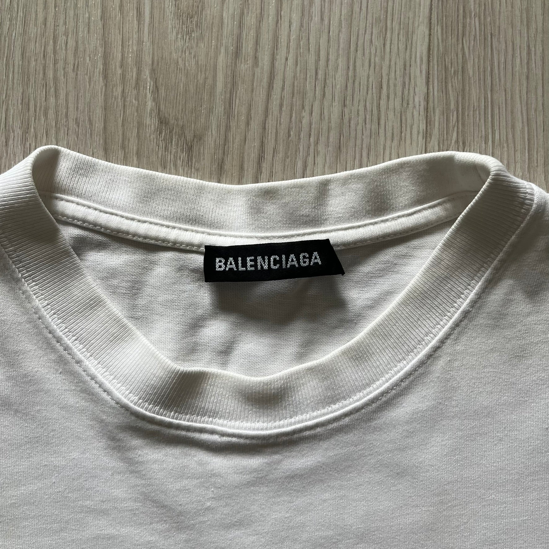 Balenciaga white copyright tee from the Autumn/Winter 2020 collection, crafted in Portugal from premium cotton. Featuring the house’s minimalist design, it’s finished with simple black “Balenciaga” text and a copyright logo on the chest. A clean and high-quality essential.