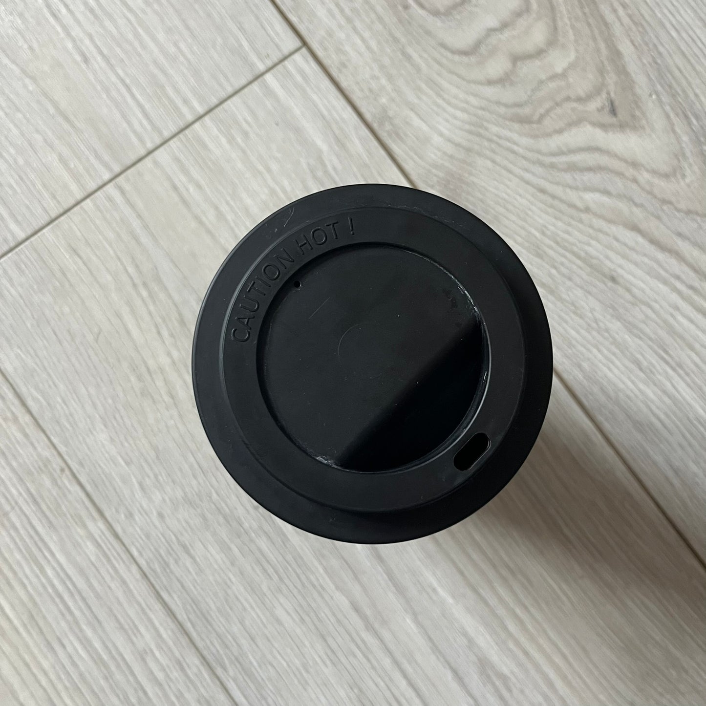 Balenciaga Dallas Black Coffee Cup crafted from glossy black porcelain with a white interior. Features a bold white Balenciaga logo with “Dallas” text underneath and a matching black rubber lid. A refined collectible showcasing everyday luxury.&nbsp;