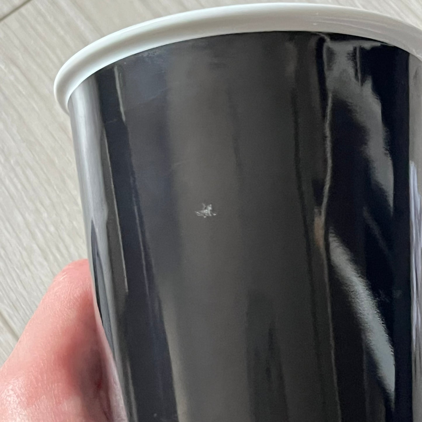 Balenciaga Dallas Black Coffee Cup crafted from glossy black porcelain with a white interior. Features a bold white Balenciaga logo with “Dallas” text underneath and a matching black rubber lid. A refined collectible showcasing everyday luxury.&nbsp;
