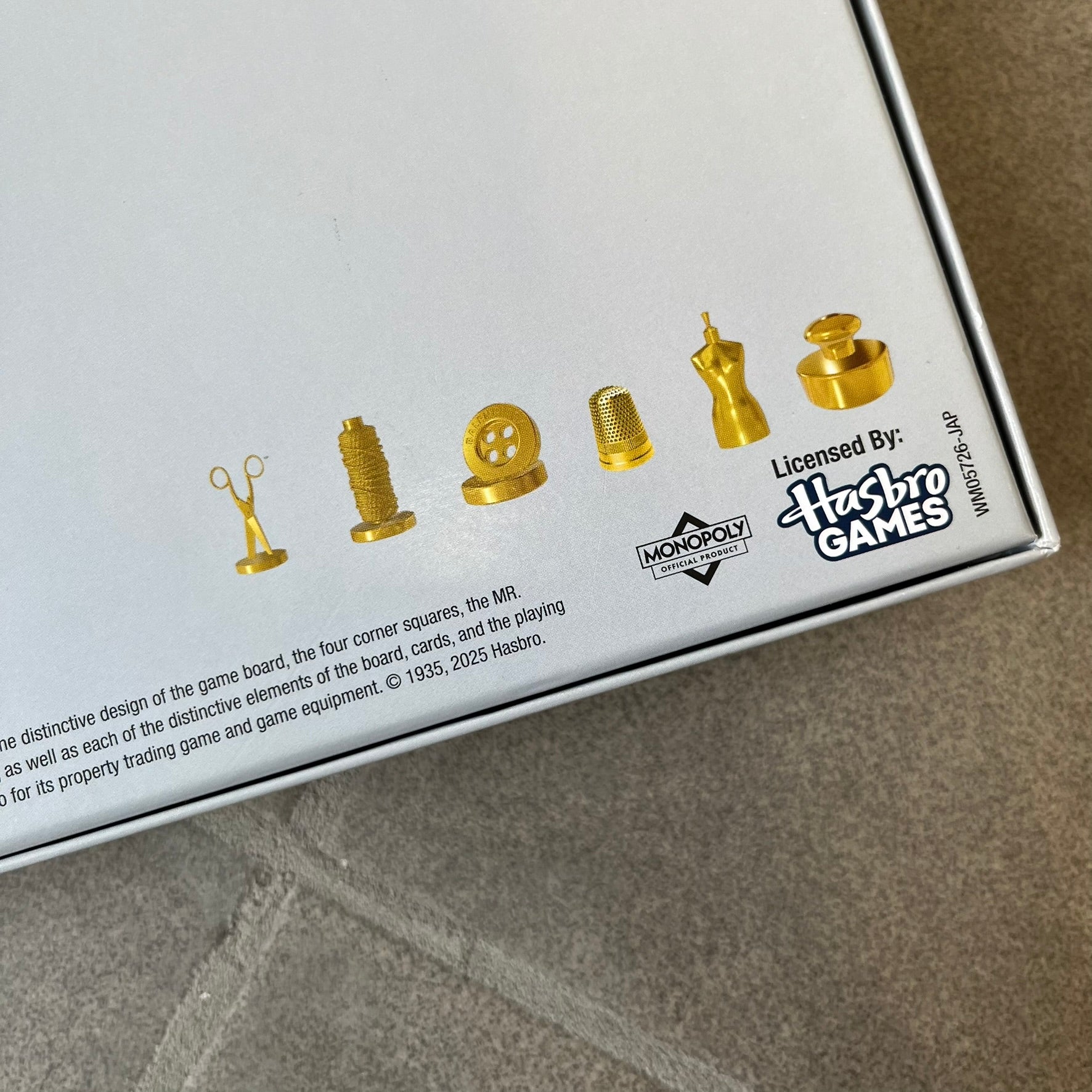 Balenciaga Monopoly 2025 VIP Gift Board Game features a custom Monopoly design made for Balenciaga. The game includes gold-tone fashion-themed playing pieces such as scissors, a thimble, thread spool, and mannequin. The board replaces standard properties with Balenciaga stores and locations, while the currency and cards feature Balenciaga branding and custom references including “Balenciaga Tax.”
