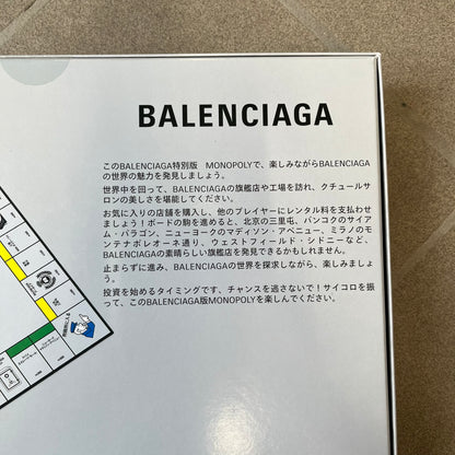Balenciaga Monopoly 2025 VIP Gift Board Game features a custom Monopoly design made for Balenciaga. The game includes gold-tone fashion-themed playing pieces such as scissors, a thimble, thread spool, and mannequin. The board replaces standard properties with Balenciaga stores and locations, while the currency and cards feature Balenciaga branding and custom references including “Balenciaga Tax.”

