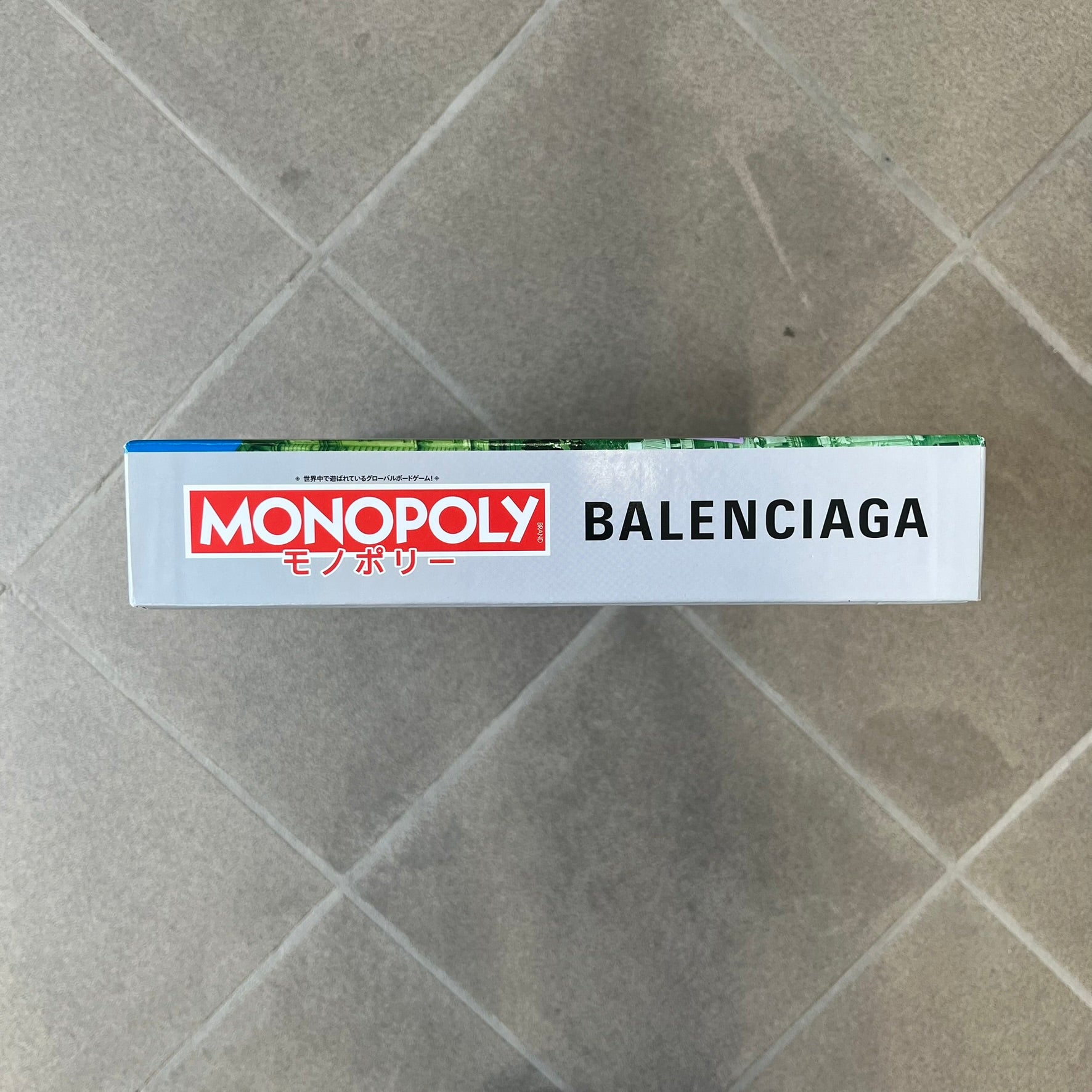 Balenciaga Monopoly 2025 VIP Gift Board Game features a custom Monopoly design made for Balenciaga. The game includes gold-tone fashion-themed playing pieces such as scissors, a thimble, thread spool, and mannequin. The board replaces standard properties with Balenciaga stores and locations, while the currency and cards feature Balenciaga branding and custom references including “Balenciaga Tax.”
