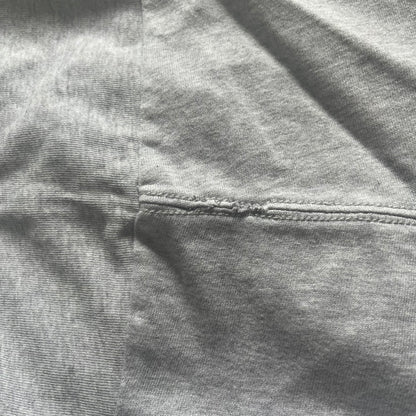 Close-up of gray fabric with a focus on texture and stitching.
