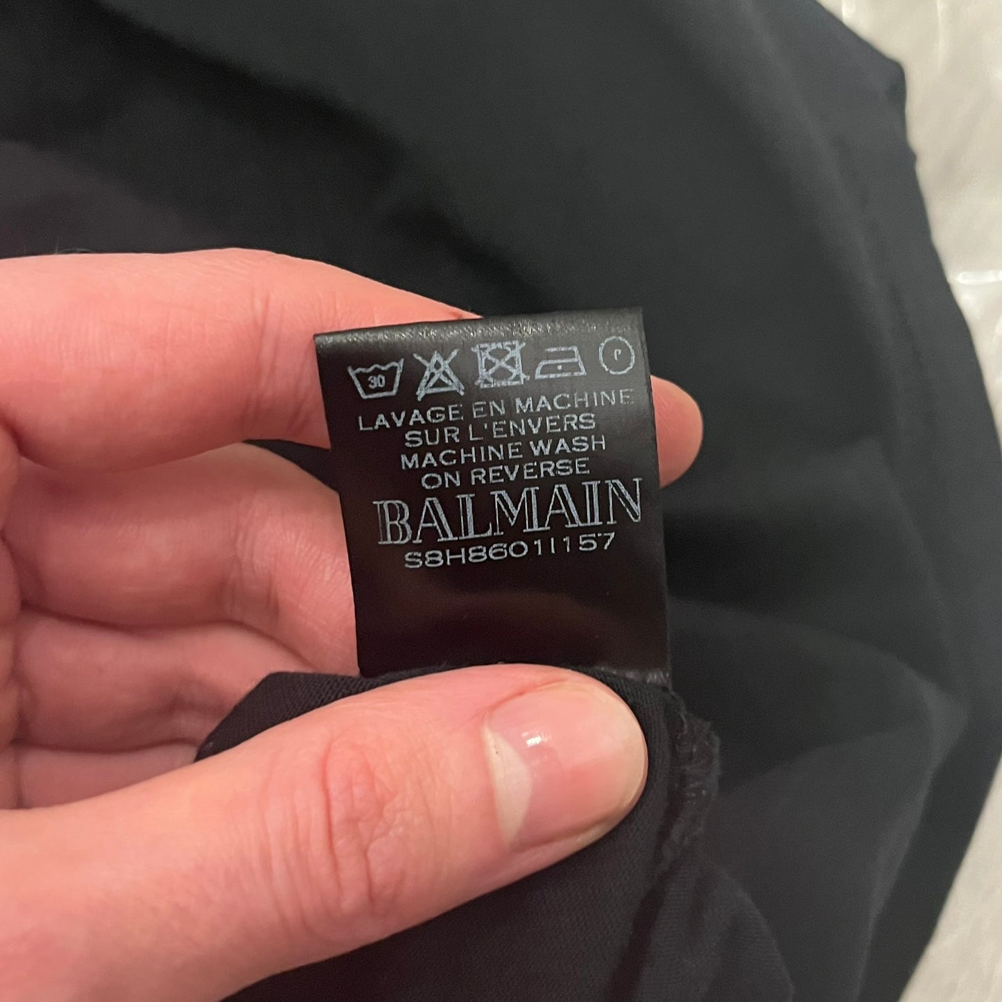 Balmain 2018 Black Tee featuring a discreet black Balmain Paris logo across the chest for a low-key, monochromatic effect. Constructed from soft 100% cotton and produced in Portugal, it embodies the brand’s modern, minimal direction.