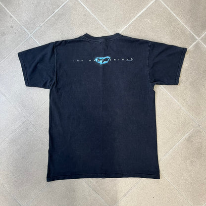 Batman The Dark Knight 2008 Joker Promo Tee features a black construction made on an Anvil blank, with Heath Ledger as the Joker holding a Batman playing card printed on the front. The upper back has The Dark Knight logo with small DC Comics 2008 licensing text underneath.
