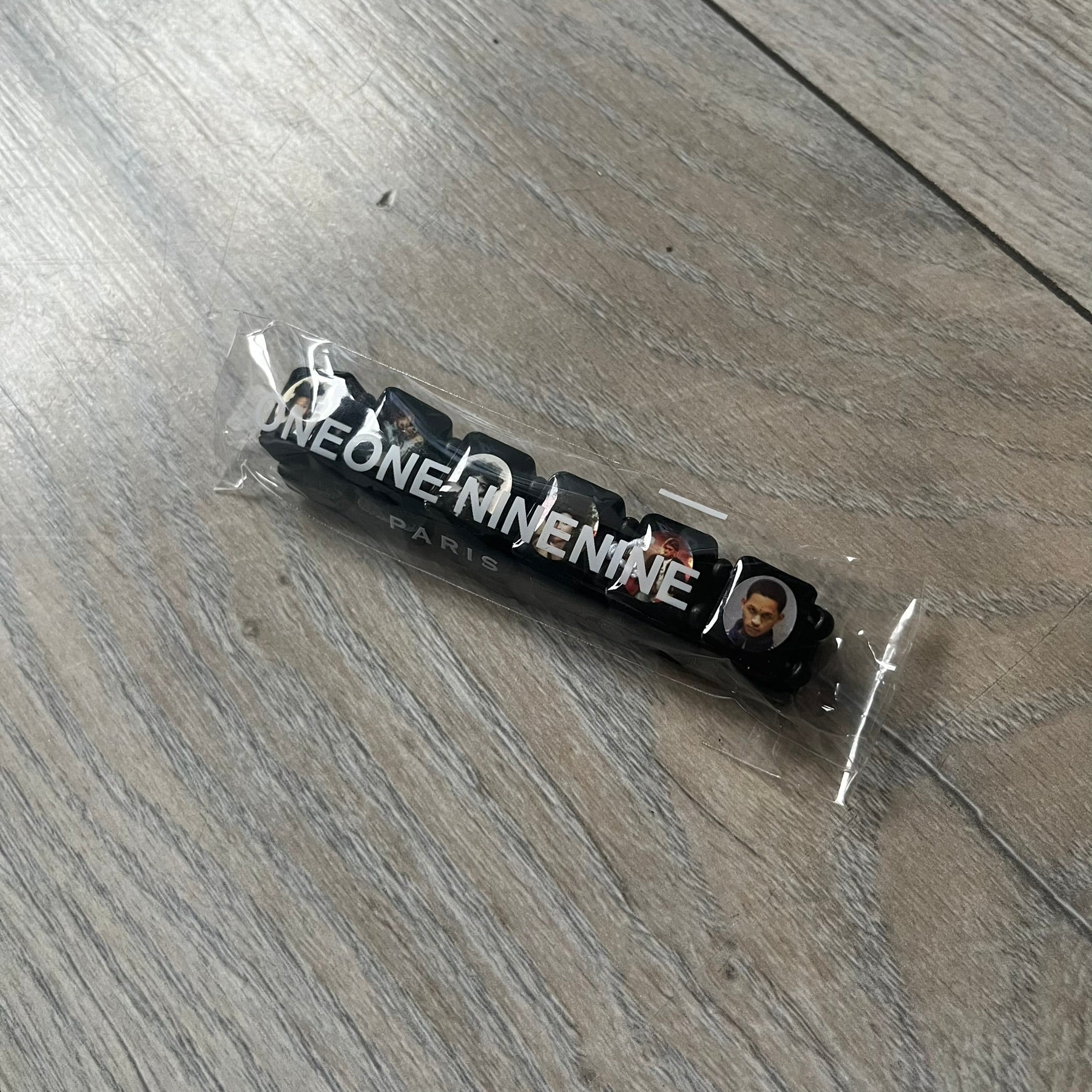 Black “Forever 27 Club” bracelet by Bazo 1199, showcasing painted wooden beads and engraved portraits of legendary artists from the infamous 27 Club like Kurt Cobain, Basquiat, and Fredo Santana. Signed “forever 27 club” and “1199” on the inside.