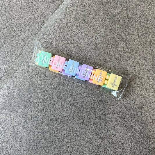 Bazo 1199 “God’s Lonely Kids” Bracelet is a multicolor silicone bead bracelet featuring crystal cross details on the outside of each bead. The interior is engraved with the 1199 logo and “God’s Lonely Kids” text.&nbsp;