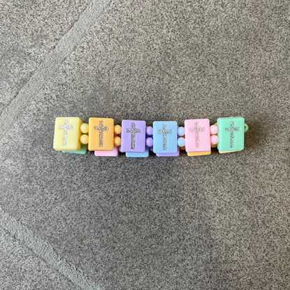 Bazo 1199 “God’s Lonely Kids” Bracelet is a multicolor silicone bead bracelet featuring crystal cross details on the outside of each bead. The interior is engraved with the 1199 logo and “God’s Lonely Kids” text.&nbsp;