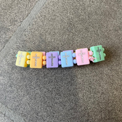 Bazo 1199 “God’s Lonely Kids” Bracelet is a multicolor silicone bead bracelet featuring crystal cross details on the outside of each bead. The interior is engraved with the 1199 logo and “God’s Lonely Kids” text.&nbsp;