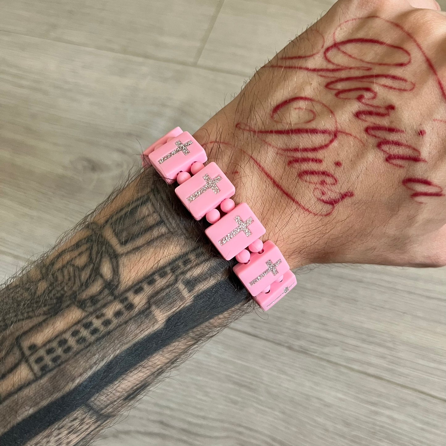Bazo 1199 “God’s Lonely Kids” Bracelet is a pink silicone bead bracelet featuring crystal cross details on the outside of each bead. The interior is engraved with the 1199 logo and “God’s Lonely Kids” text. Comes with a plastic bag.&nbsp;