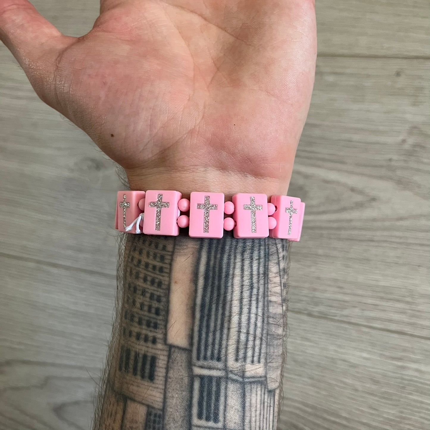 Bazo 1199 “God’s Lonely Kids” Bracelet is a pink silicone bead bracelet featuring crystal cross details on the outside of each bead. The interior is engraved with the 1199 logo and “God’s Lonely Kids” text. Comes with a plastic bag.&nbsp;