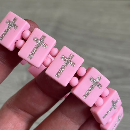 Bazo 1199 “God’s Lonely Kids” Bracelet is a pink silicone bead bracelet featuring crystal cross details on the outside of each bead. The interior is engraved with the 1199 logo and “God’s Lonely Kids” text. Comes with a plastic bag.&nbsp;
