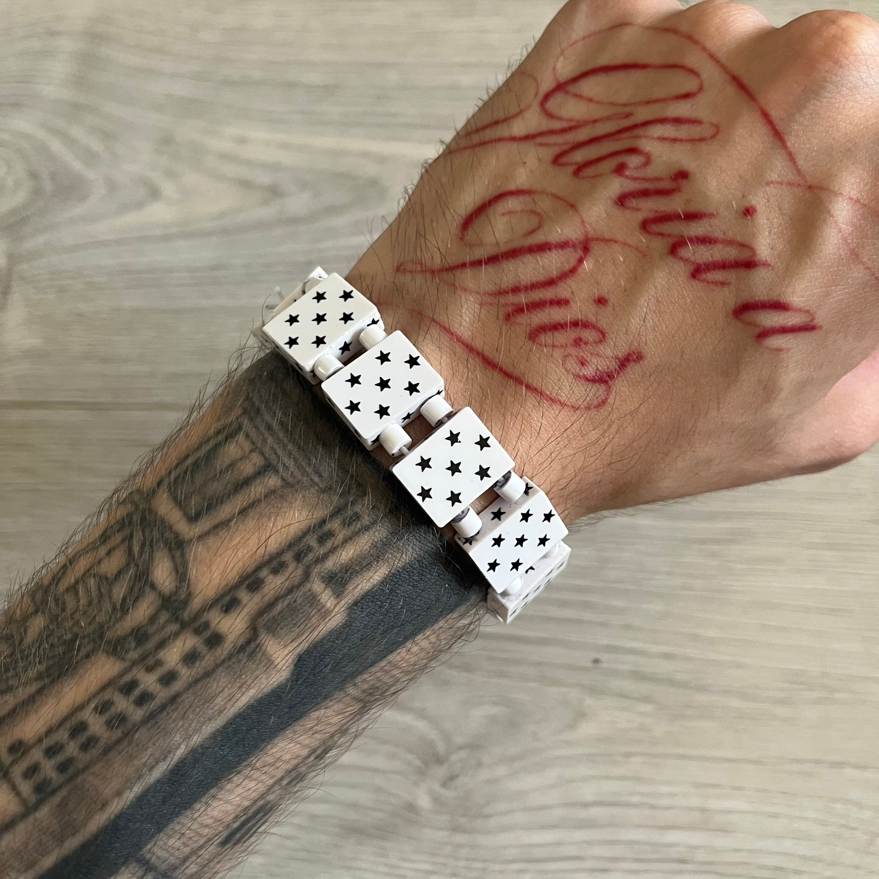 Bazo 1199 “White on Black” Stars Bracelet is a acetate bead bracelet featuring white beads with black star graphics printed on the tops and sides. One bead is marked with a red 1199 logo on the inside. It comes with the original foil packaging.
