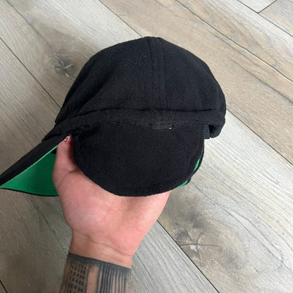 Ben 10 Alien Force Earflap 2011 Hat is a black polyester kids-size hat with green interior lining and earflaps on both sides. The front features embroidered Ben 10 character graphics with “Ben 10 Alien Force” text. Finished with an official 2011 Cartoon Network tag and a soft overall construction.