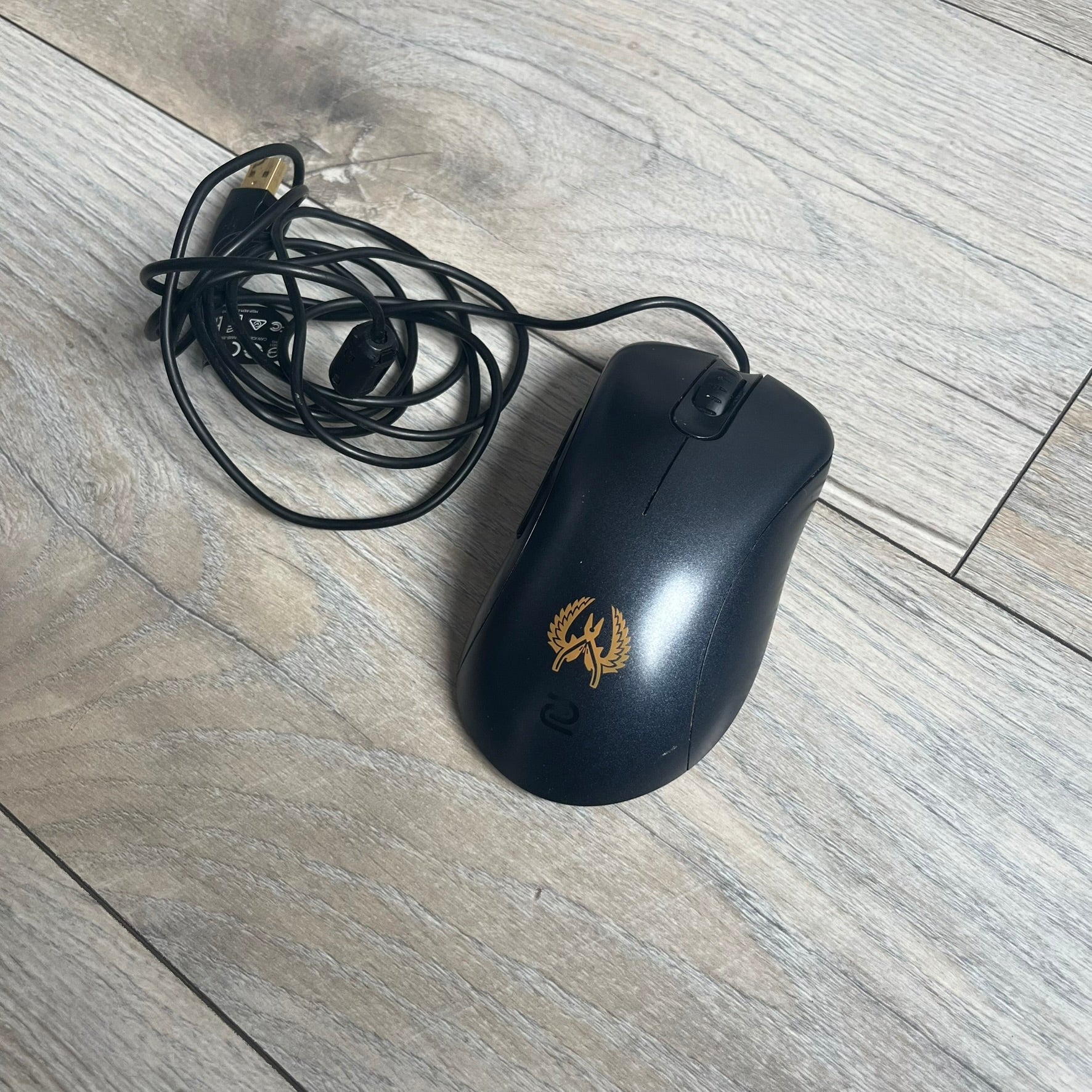 BenQ Zowie EC1-B CS:GO Special Edition Gaming Mouse is a wired ergonomic mouse designed for right-handed users, featuring a PixArt 3360 optical sensor with adjustable DPI settings. The black casing includes a CS:GO Guardian graphic, with a 1000 Hz polling rate, five buttons, and a scroll wheel for precise control. It has a USB connection, 2-meter cable, and a lightweight 94 g construction optimized for palm and claw grip styles.