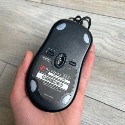 BenQ Zowie EC1-B CS:GO Special Edition Gaming Mouse is a wired ergonomic mouse designed for right-handed users, featuring a PixArt 3360 optical sensor with adjustable DPI settings. The black casing includes a CS:GO Guardian graphic, with a 1000 Hz polling rate, five buttons, and a scroll wheel for precise control. It has a USB connection, 2-meter cable, and a lightweight 94 g construction optimized for palm and claw grip styles.