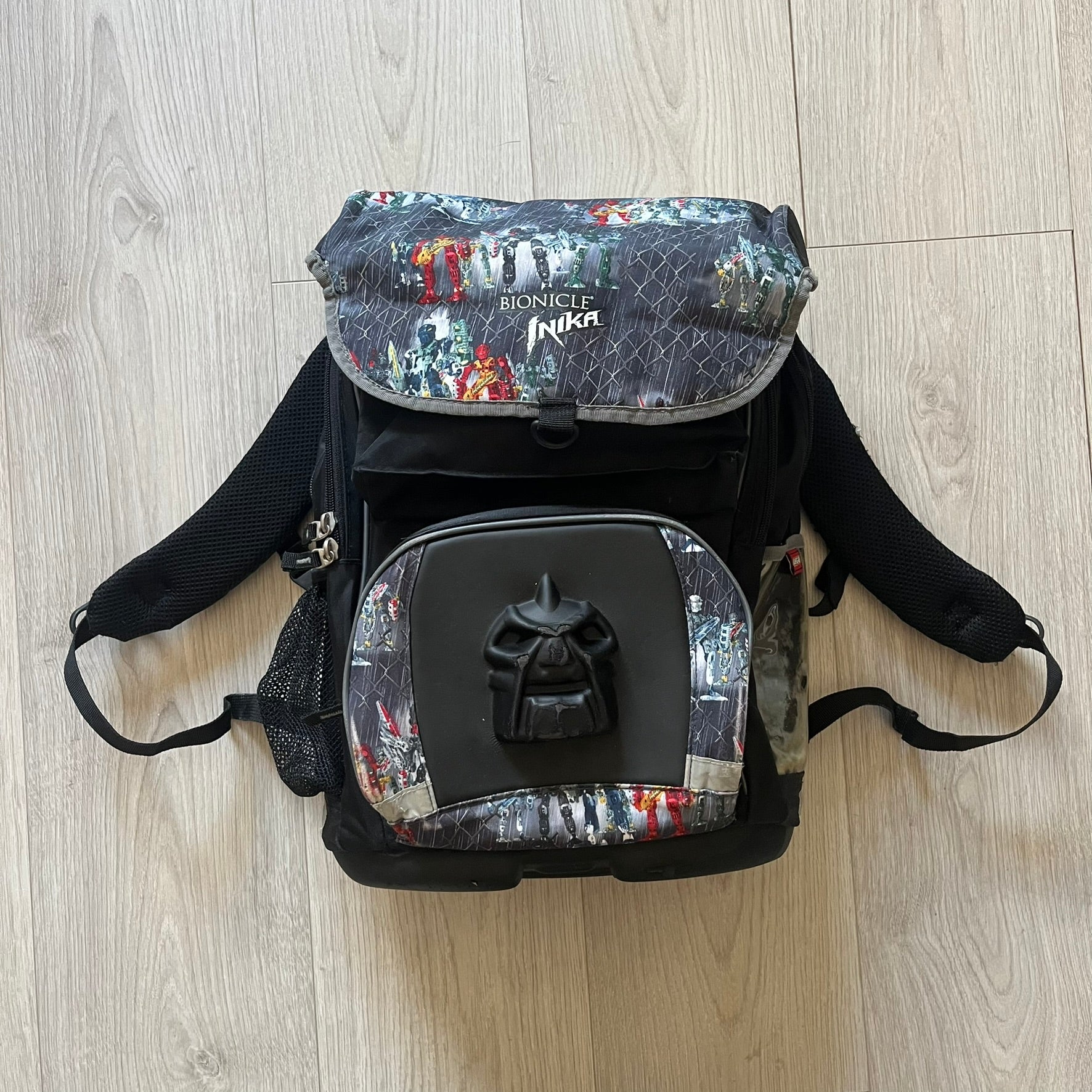 Rare 2007 Bionicle Inika "Toa Nuparu" school backpack made by Grown Up Licenses Limited under The Lego Group. Features a 3D molded Toa Nuparu head on the lower front pocket and a fully printed velcro top compartment with Bionicle figures. Spacious, durable, and reinforced for structure. A standout collectible for any true Bionicle fan.