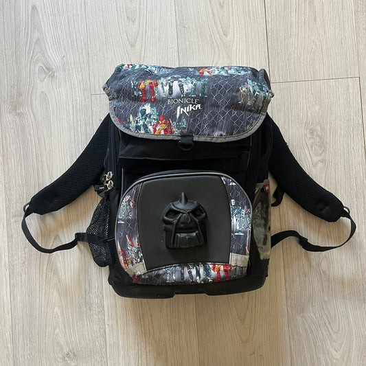 Rare 2007 Bionicle Inika "Toa Nuparu" school backpack made by Grown Up Licenses Limited under The Lego Group. Features a 3D molded Toa Nuparu head on the lower front pocket and a fully printed velcro top compartment with Bionicle figures. Spacious, durable, and reinforced for structure. A standout collectible for any true Bionicle fan.