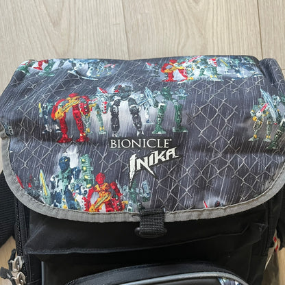 Rare 2007 Bionicle Inika "Toa Nuparu" school backpack made by Grown Up Licenses Limited under The Lego Group. Features a 3D molded Toa Nuparu head on the lower front pocket and a fully printed velcro top compartment with Bionicle figures. Spacious, durable, and reinforced for structure. A standout collectible for any true Bionicle fan.