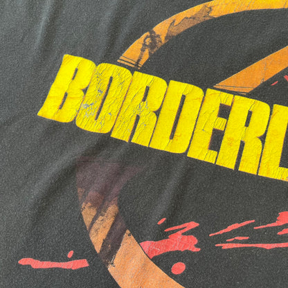 Borderlands 2 Promo 2010's Tee features a black boxy construction with a thick yellow and red Borderlands 2 logo printed on the front. A blood-splatter graphic appears behind the logo, and the shirt is made from 100% cotton.
