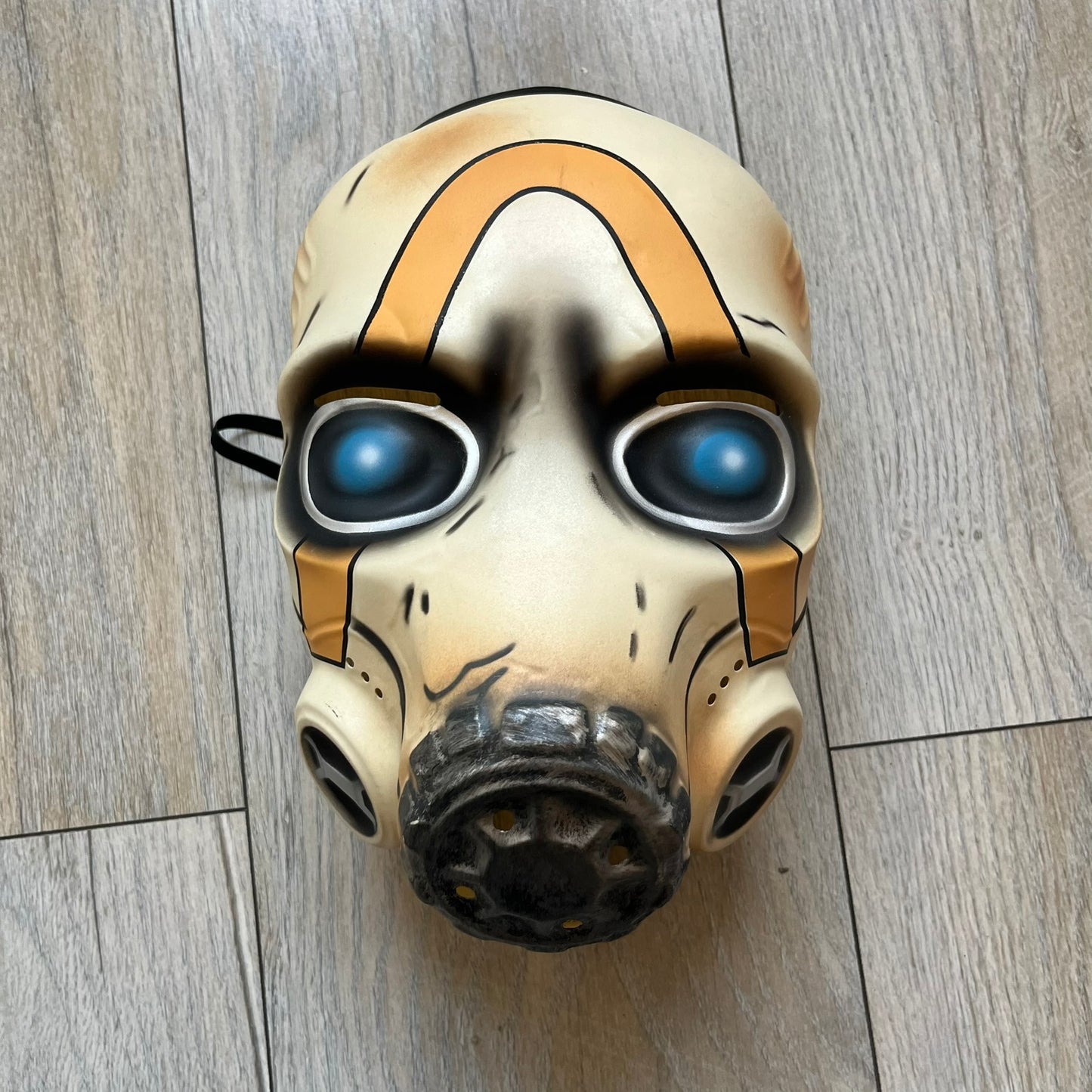 Borderlands 3 Pre-Order Exclusive Psycho Mask is a plastic character mask based on the Psycho enemy from the video game. The mask recreates the character’s white bandit mask design with detailed sculpting and includes an adjustable rubber strap for wearing. The interior features foam padding for a more secure fit on the head. Psychos are one of the most recognizable characters in the Borderlands franchise and appear as masked bandits throughout the series.