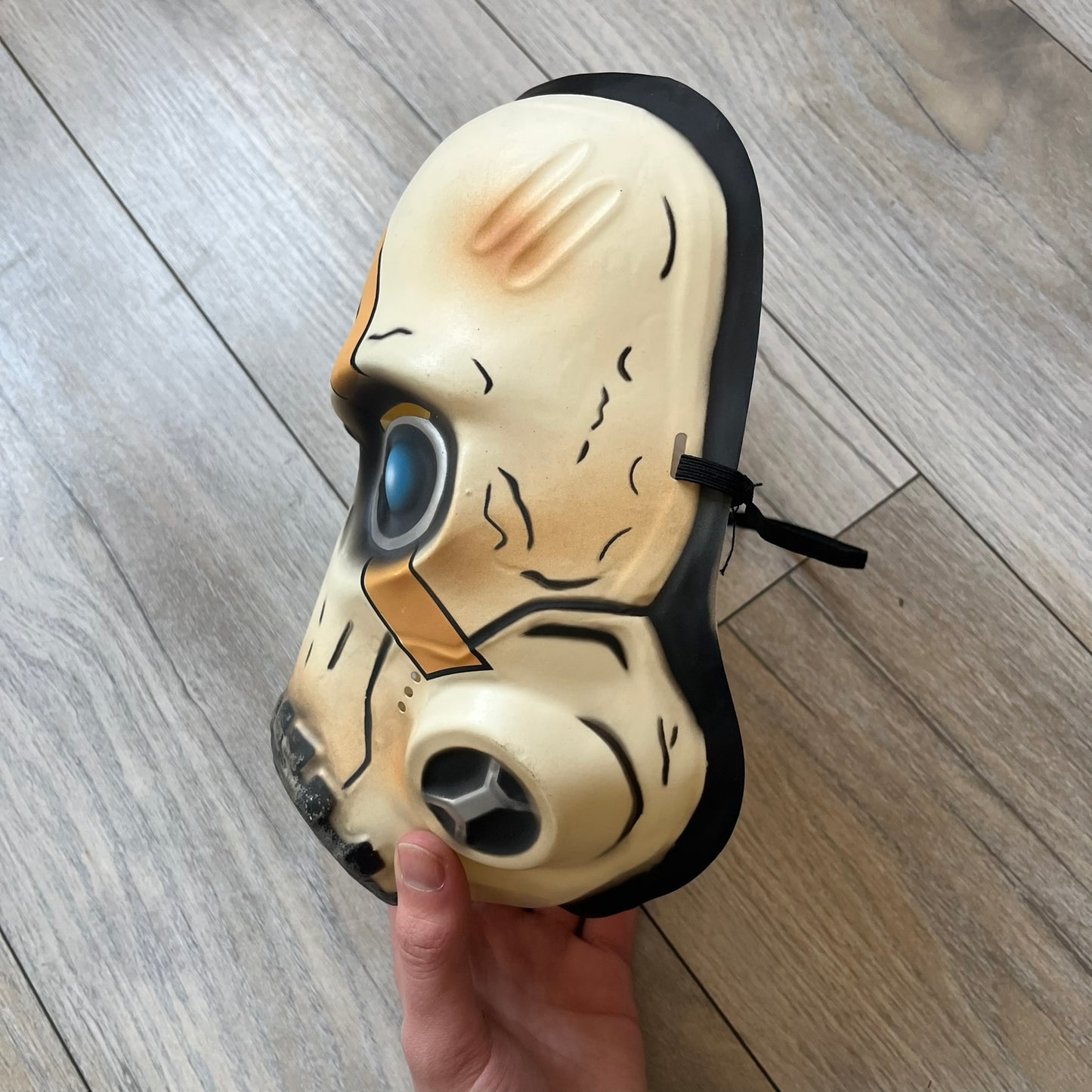 Borderlands 3 Pre-Order Exclusive Psycho Mask is a plastic character mask based on the Psycho enemy from the video game. The mask recreates the character’s white bandit mask design with detailed sculpting and includes an adjustable rubber strap for wearing. The interior features foam padding for a more secure fit on the head. Psychos are one of the most recognizable characters in the Borderlands franchise and appear as masked bandits throughout the series.