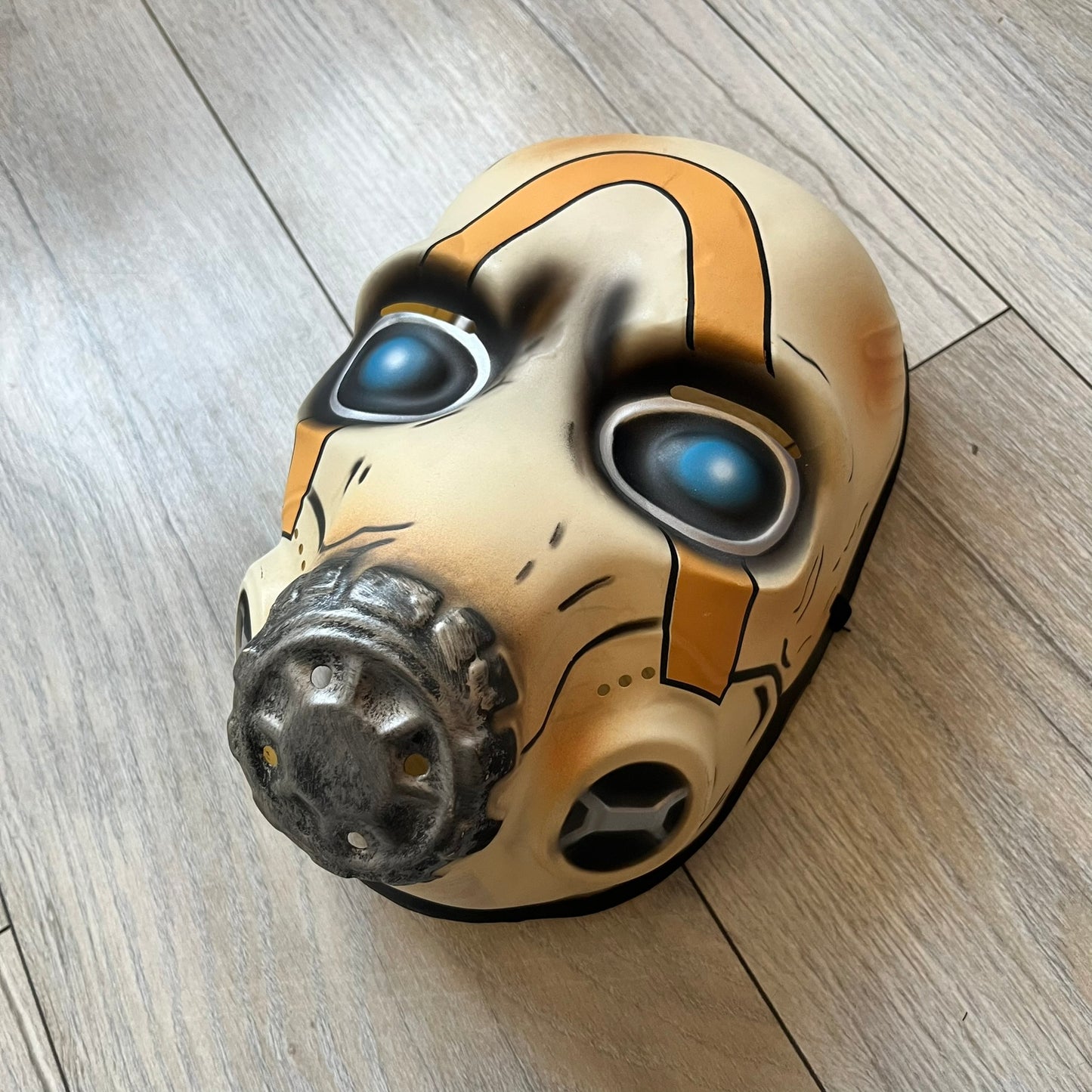 Borderlands 3 Pre-Order Exclusive Psycho Mask is a plastic character mask based on the Psycho enemy from the video game. The mask recreates the character’s white bandit mask design with detailed sculpting and includes an adjustable rubber strap for wearing. The interior features foam padding for a more secure fit on the head. Psychos are one of the most recognizable characters in the Borderlands franchise and appear as masked bandits throughout the series.