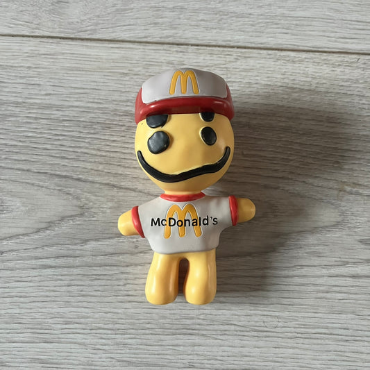 CPFM x McDonald’s Cactus Buddy Figure from the 2022 collaboration between Cactus Plant Flea Market and McDonald’s. Features the signature yellow character wearing a red and white McDonald’s tee with CPFM’s iconic four-eye design. Released as part of the adult Happy Meal collection in FW22, licensed on the back.