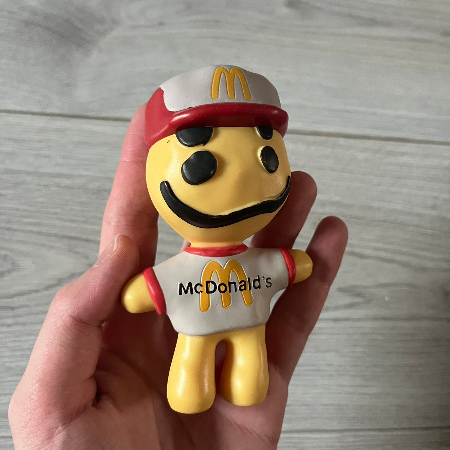CPFM x McDonald’s Cactus Buddy Figure from the 2022 collaboration between Cactus Plant Flea Market and McDonald’s. Features the signature yellow character wearing a red and white McDonald’s tee with CPFM’s iconic four-eye design. Released as part of the adult Happy Meal collection in FW22, licensed on the back.