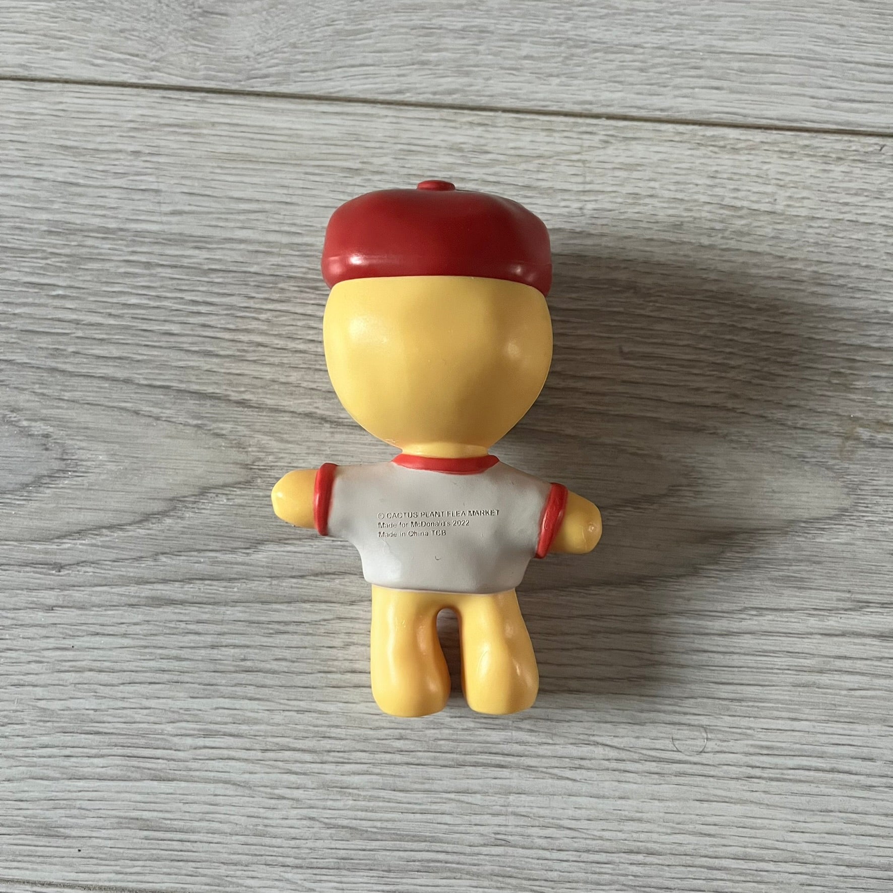 CPFM x McDonald’s Cactus Buddy Figure from the 2022 collaboration between Cactus Plant Flea Market and McDonald’s. Features the signature yellow character wearing a red and white McDonald’s tee with CPFM’s iconic four-eye design. Released as part of the adult Happy Meal collection in FW22, licensed on the back.