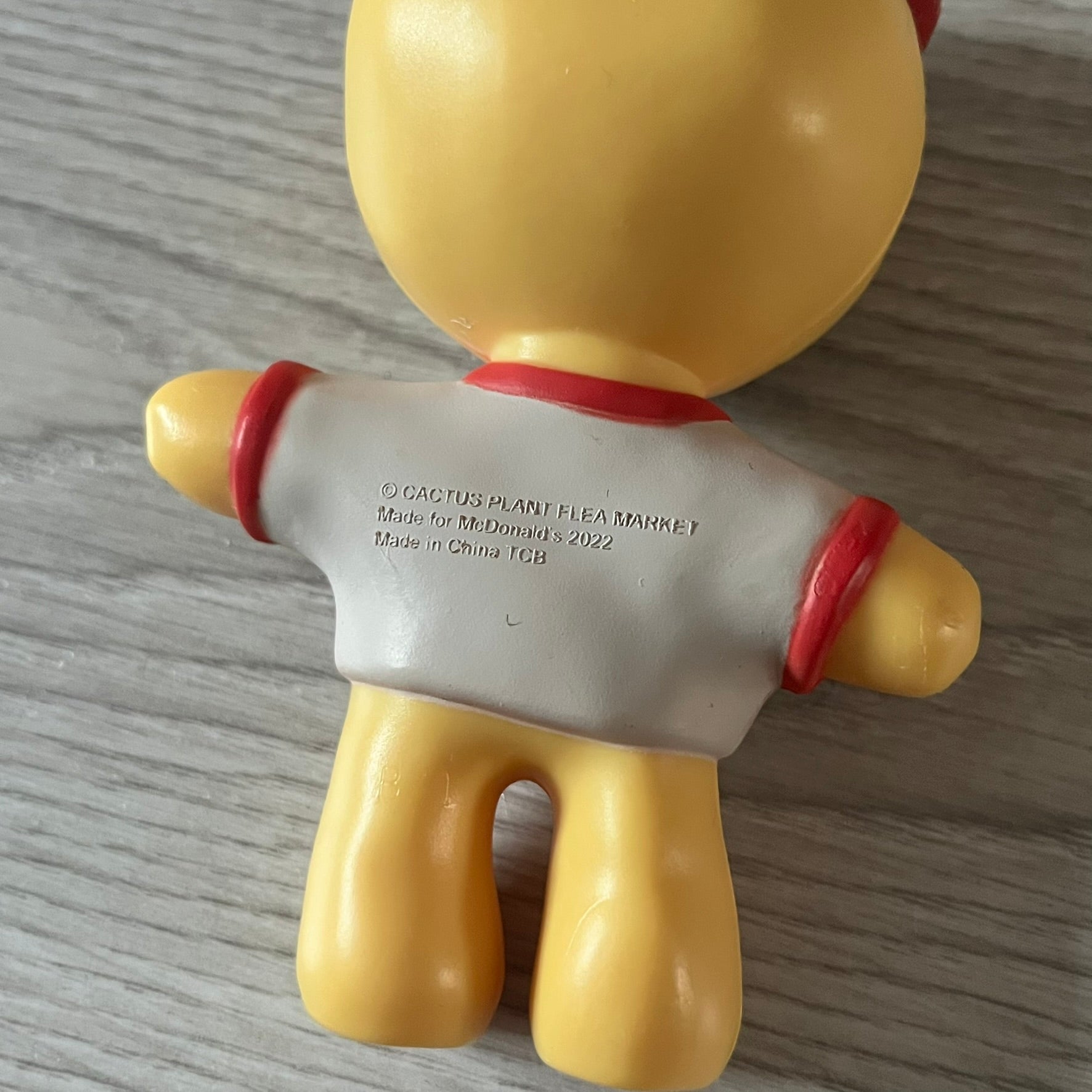 CPFM x McDonald’s Cactus Buddy Figure from the 2022 collaboration between Cactus Plant Flea Market and McDonald’s. Features the signature yellow character wearing a red and white McDonald’s tee with CPFM’s iconic four-eye design. Released as part of the adult Happy Meal collection in FW22, licensed on the back.