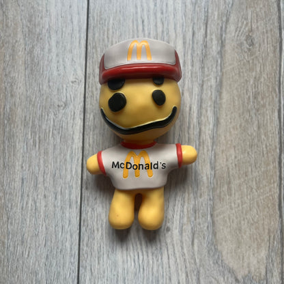 CPFM x McDonald’s Cactus Buddy Figure from the 2022 collaboration between Cactus Plant Flea Market and McDonald’s. Features the signature yellow character wearing a red and white McDonald’s tee with CPFM’s iconic four-eye design. Released as part of the adult Happy Meal collection in FW22, licensed on the back.