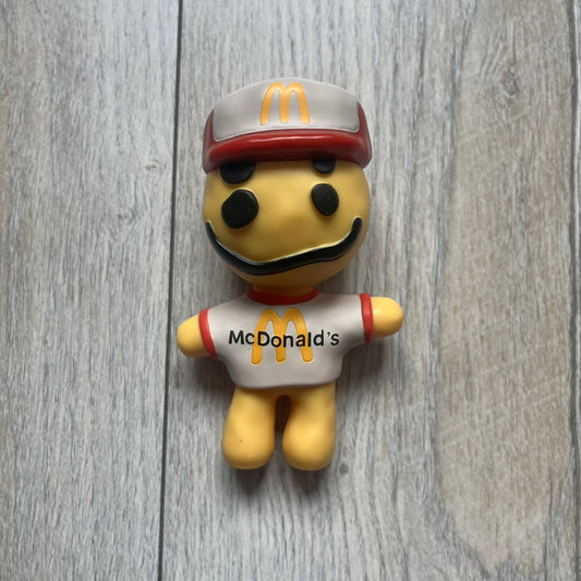CPFM x McDonald’s Cactus Buddy Figure from the 2022 collaboration between Cactus Plant Flea Market and McDonald’s. Features the signature yellow character wearing a red and white McDonald’s tee with CPFM’s iconic four-eye design. Released as part of the adult Happy Meal collection in FW22, licensed on the back.