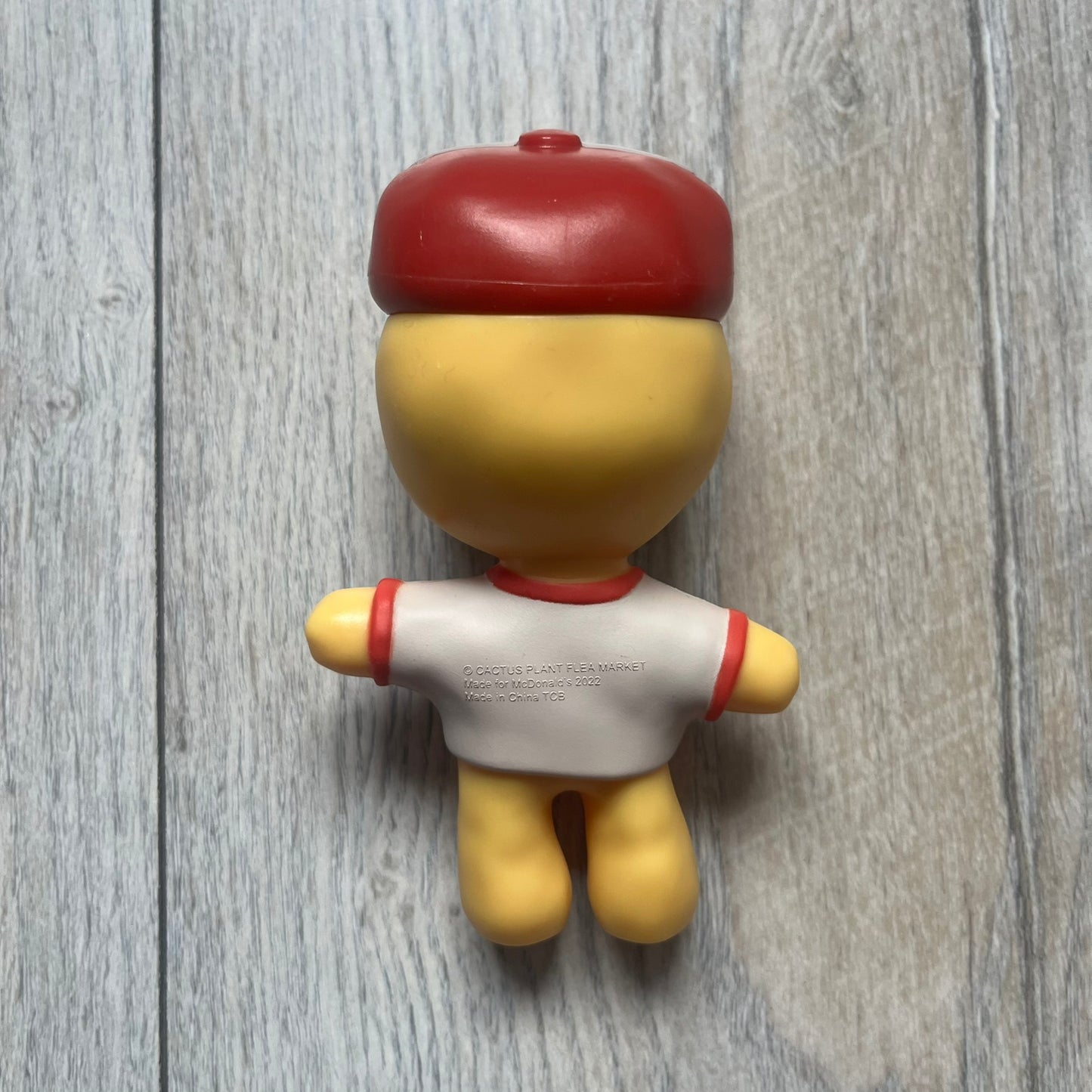 CPFM x McDonald’s Cactus Buddy Figure from the 2022 collaboration between Cactus Plant Flea Market and McDonald’s. Features the signature yellow character wearing a red and white McDonald’s tee with CPFM’s iconic four-eye design. Released as part of the adult Happy Meal collection in FW22, licensed on the back.