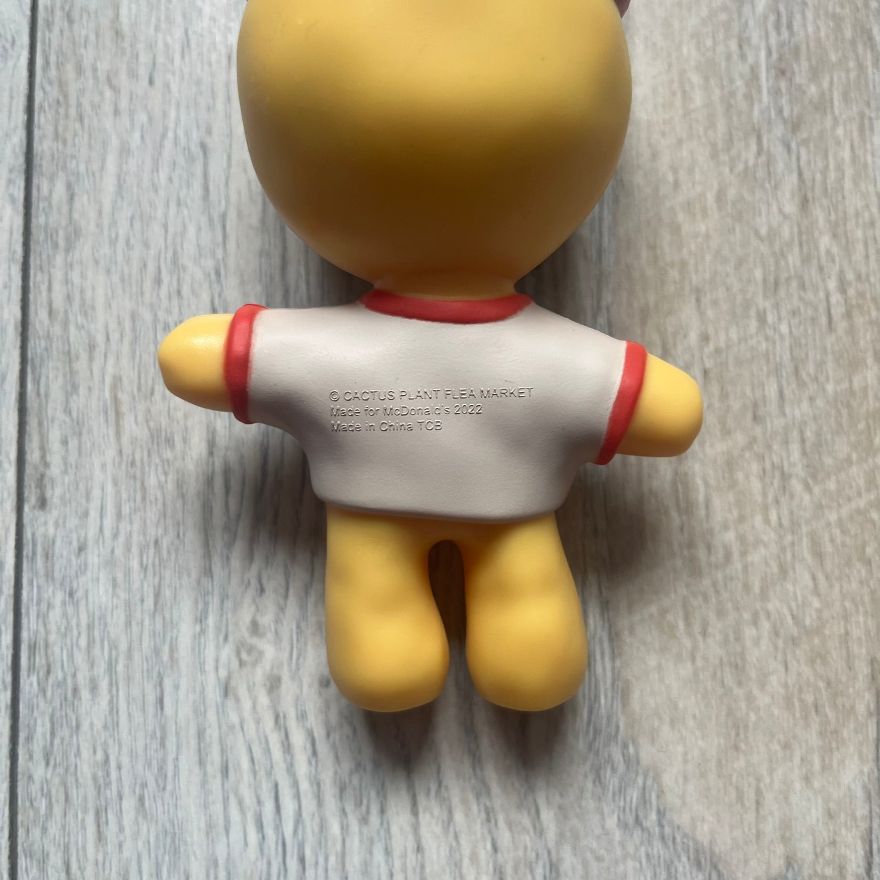 CPFM x McDonald’s Cactus Buddy Figure from the 2022 collaboration between Cactus Plant Flea Market and McDonald’s. Features the signature yellow character wearing a red and white McDonald’s tee with CPFM’s iconic four-eye design. Released as part of the adult Happy Meal collection in FW22, licensed on the back.