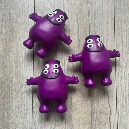Official CPFM x McDonald’s Grimace collectible from the FW22 drop. The purple figure showcases the McDonald’s icon reimagined with CPFM’s four-eye design. Released October 3rd, 2022, as part of the limited adult Happy Meal collection, licensed on the back.